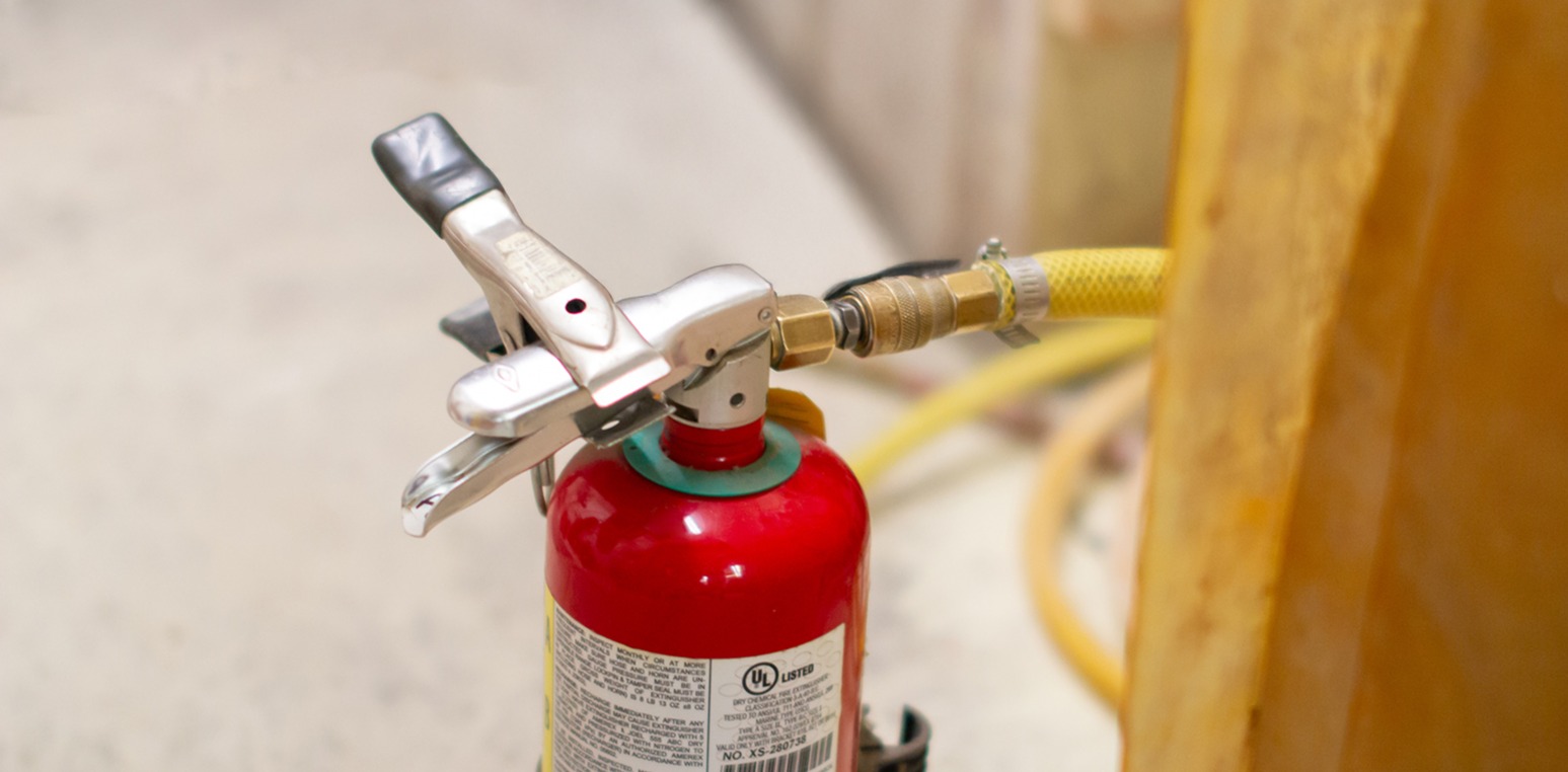 Fire extinguisher being re-filled suppression chemicals during 6-year service